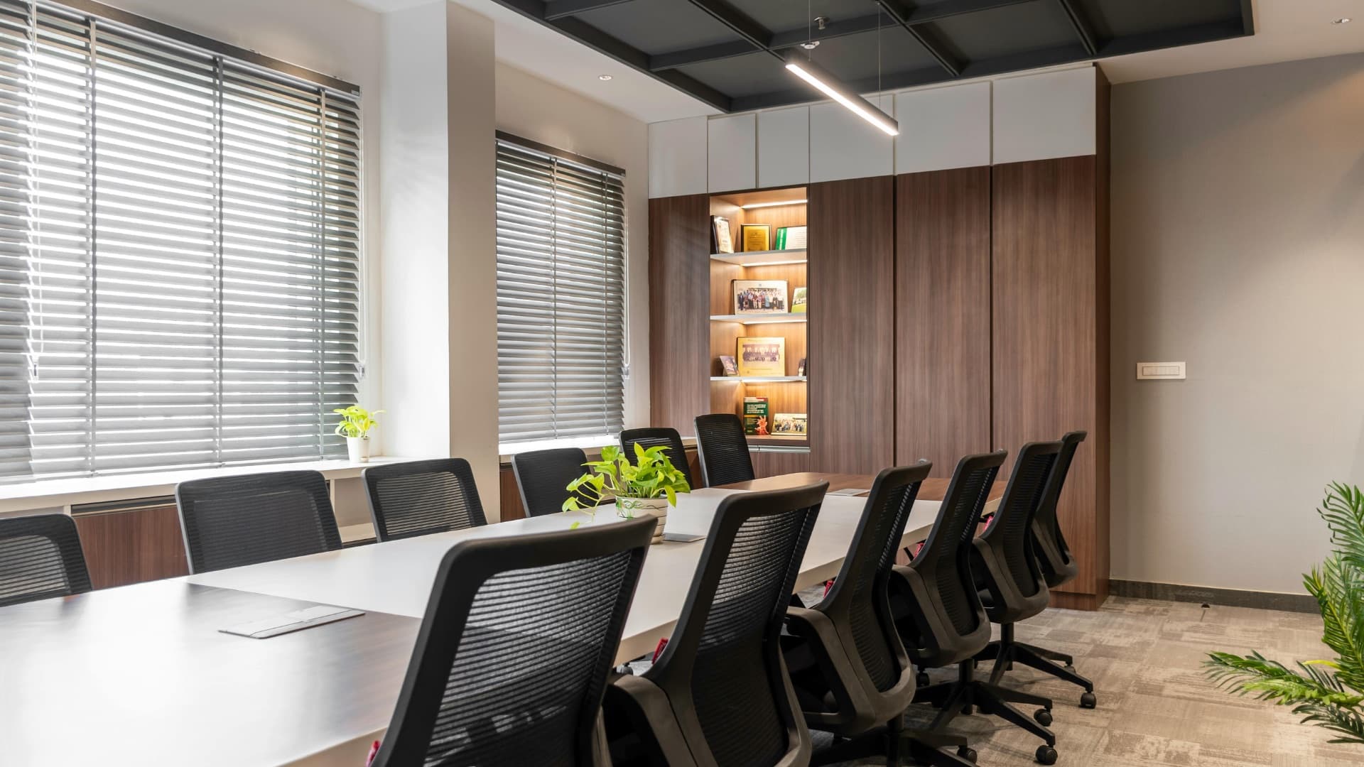 A boardroom table, chairs pulled up and waiting